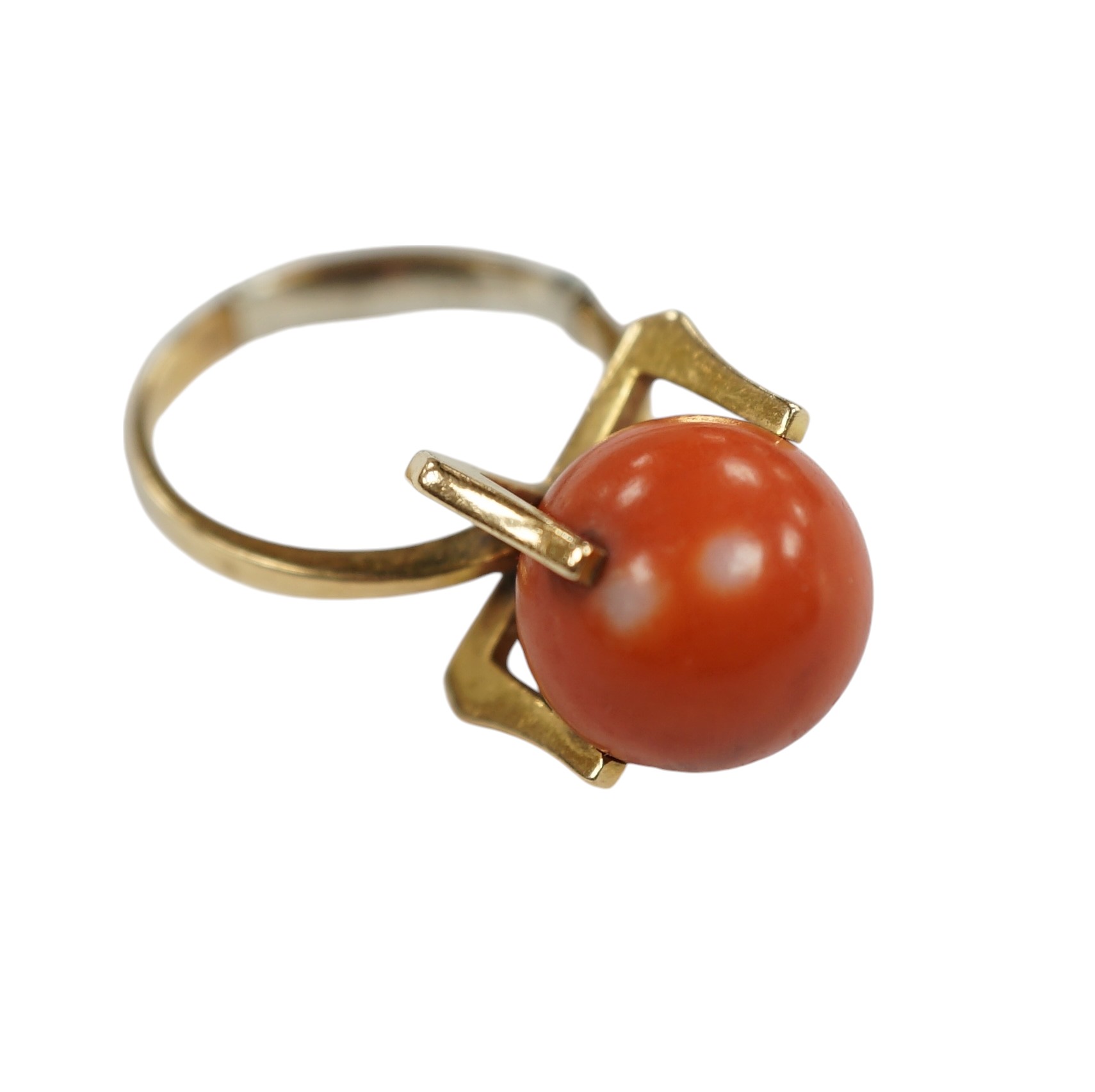 A continental yellow metal and single stone coral bead set dress ring, size O, gross weight 7.7 grams. Condition - fair